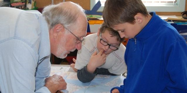 George Brooks helps two Magnetawan Central School students find the Magnetawan River on a map of Ontario. Brooks presented to the primary and junior classes at MCS about fish in the area. George Brooks helps two Magnetawan Central School students find the Magnetawan River on a map of Ontario. Brooks presented to the primary and junior classes at MCS about fish in the area.