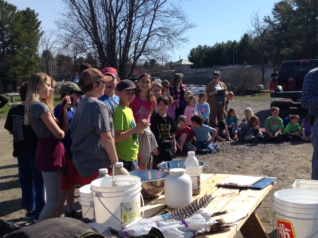 students and teachers observe the work area at the dock